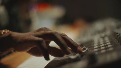 Close-Up of Hand of Sound Engineer Adjusting Faders on Audio Mixer Stock Footage 302710244