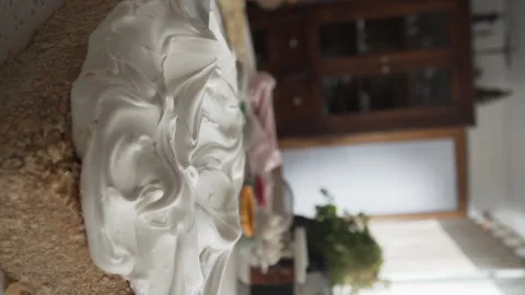 Close up on hand with spatula making the last details in meringue icing of sheet Video stock 240770395