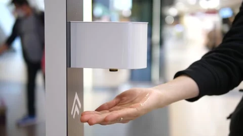 Close up of hand sprayed by contactless auto sanitizer dispenser device Stock Footage 141681932