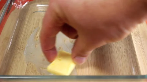 Close-up of Hand Spreading Butter on a Baking Dish Stock Footage 288704423