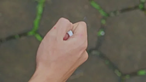 Close-up of hand squeeze burning cigarette Stock Footage 332386780