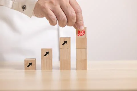 Close up hand stack Wooden block to upside bar graph. Concept for growth grap Stock Photos