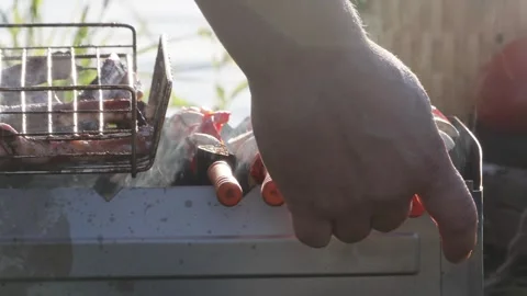 Close up of hand starting barbecue grill, fire ignition outdoor cooking Stock Footage 332307609