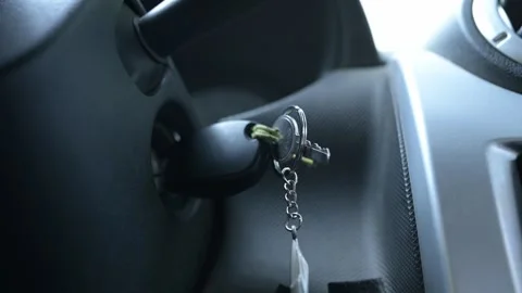 Close-up of a hand starting a car engine with a key, revving the motor several Stock Footage 319494383