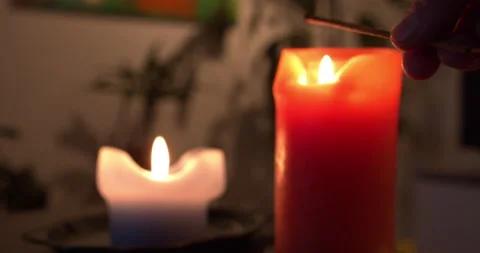 Close-up of hand starting an incense stick on a candle. Relax concept Stock Footage 146177547
