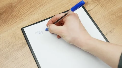 Close-up of hand starting to write on paper with blue pen in peaceful indoor Stock Footage 309567229