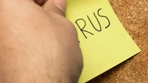 Close up hand sticks Virus note on corkboard Stock-Footage 127196021