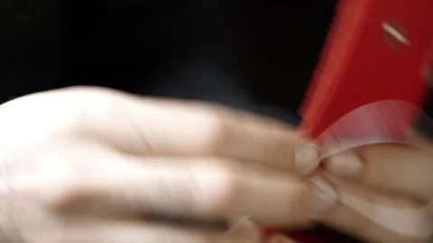 Close-Up Hand Stitching Opposite Edge of Red Leather Wallet with White Thread Stock Footage 314961913