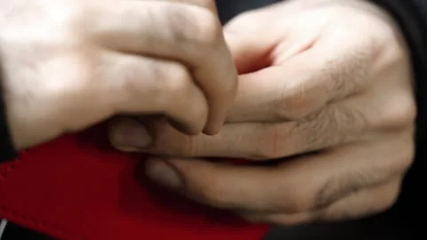 Close-Up Hand Stitching Red Leather Wallet with White Thread Stock Footage 314962258