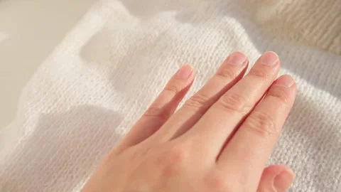 Close up hand stroking over the surface knitted soft wool cloth or warm fluffy Stock Footage 223672311