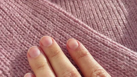 Close up hand stroking over the surface knitted soft wool cloth or warm fluffy Video stock 225451054