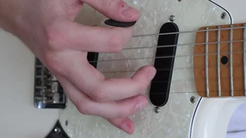 Close up of a hand strumming a guitar Stock Footage 333463115