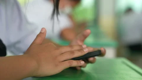 Close up hand of student holding mobile phone use learning in classroom Stock-Footage 221610152
