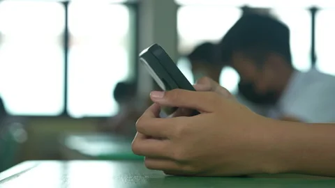 Close up hand of student holding mobile phone use learning in classroom Stockbeeldmateriaal 221612590