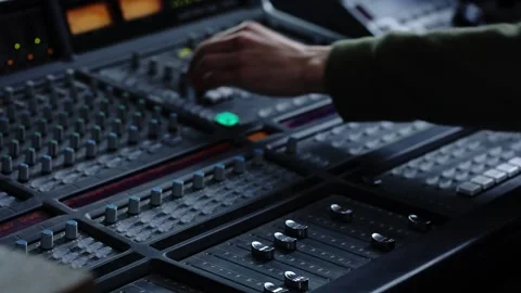Close-up of a hand on a studio mixing console. Selective focus. Using a digit Stock Footage 154007147