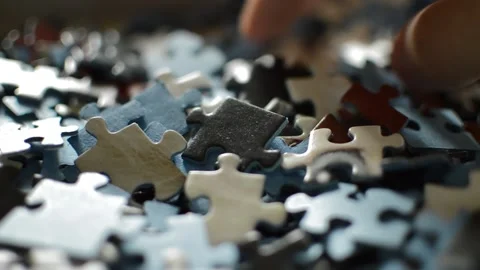 Close-up hand take a puzzle piece. solution of the puzzle game concept. Stock Footage 219320736