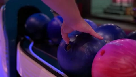 Close-up of hand takes the bowling ball, fingers get into holes Stock Footage 220208874