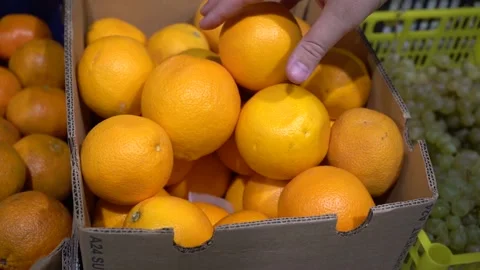 Close-up hand takes an orange Stock Footage 139674635