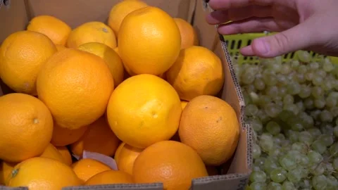 Close-up hand takes an orange Video stock 139677434