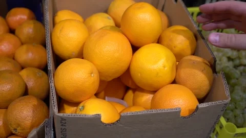 Close-up hand takes an orange Stock Footage 139678836