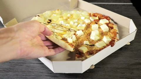 Close-up hand that takes a slice of pizza from a white cardboard box. Hand Stock Footage 122741665