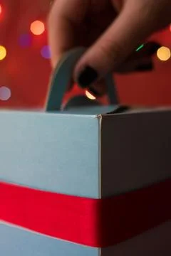Close Up Of Hand Taking Blue Gift Box Foto stock