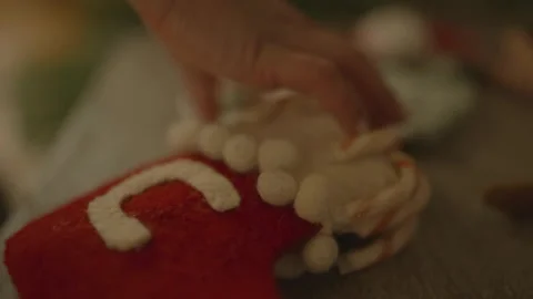 Close-up hand taking Christmas stocking 库存影片 334031629