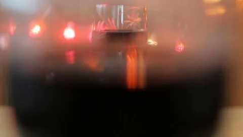 Close up hand taking glass with red wine. Lights background Stock Footage 75982835