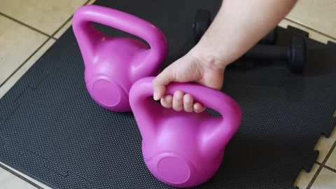 Close up hand taking a kettlebell from black fitness zone Stock Footage 237729273