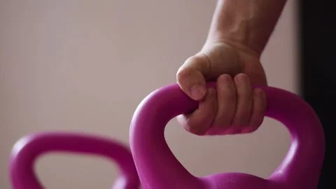 Close up hand taking up a kettlebell Stock Footage 237729190