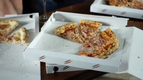 Close-up hand taking piece of pizza from the box. Pizza party, friends, happy Stock Footage 93251435
