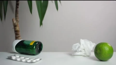 Close-up of a hand taking pills and a glass of water from a table Stock-Footage 308937317