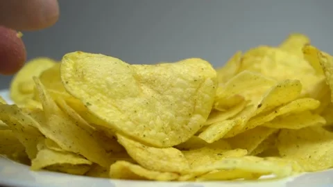 Close up hand taking a potato chips. Stock Footage 86575473