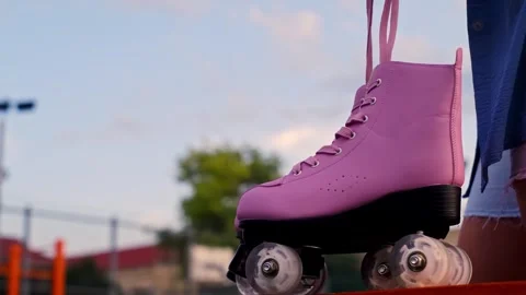 Close-up hand taking roller skates in a skate park, outdoor training, ice skatin Stock Footage 258344403