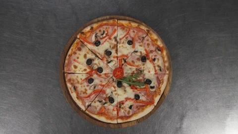 Close-up of a hand taking slice of freshly baked pizza. Man takes piece of pizza 스톡 동영상 121413115