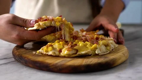 Close up a hand taking a slice pizza. hands of male taking pizza slices at Stock Footage 336586625