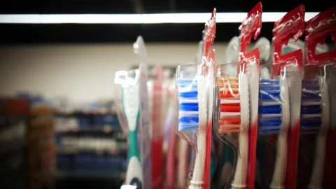 Close-up of a hand taking a tooth brush from a retail display Stock Footage 332153192