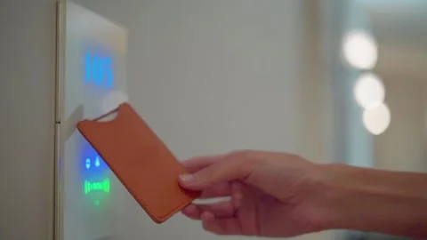 Close-up of a hand tapping with contactless keycard to unlock a modern luxury Stock Footage 337157025
