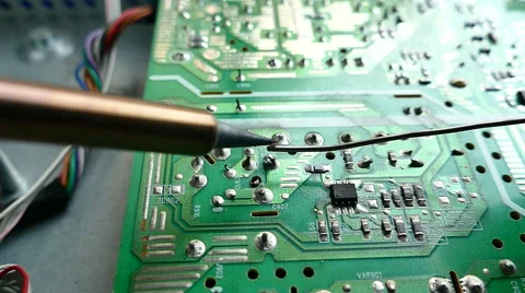 Close up of hand of technical Electronics Soldering a computer circuit board Stock Footage 69060408