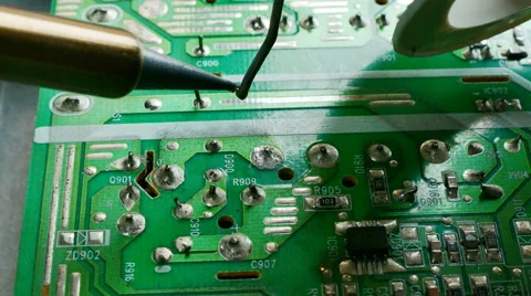 Close up of hand of technical Electronics Soldering a computer circuit board Stock Footage 69060685