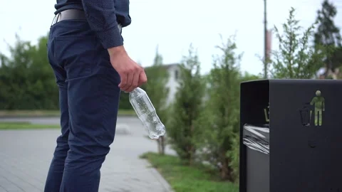 Close up hand throwing empty plastic bottle into the trash. Man and nature Video stock 113555878