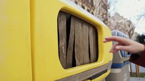 Close-up of hand throwing empty plastic bottles into recycling bin. Video stock 336059181