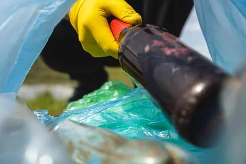 Close-up of a hand throwing garbage into a plastic bag. View from inside the bag Stock Photos