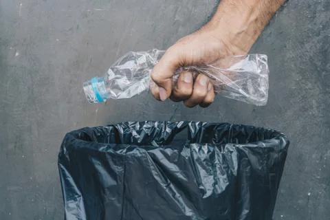 Close up hand throwing plastic bottle into the recycling bin,  Recycling Conc Stock Photos