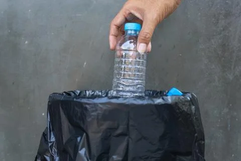 Close up hand throwing plastic bottle into the recycling bin,  Recycling Conc Stock Photos