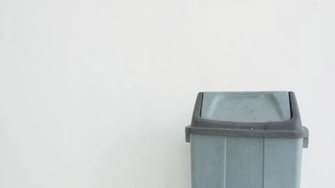 Close-up of a hand throwing a used bottle into a trash can. Stock Footage 337393311