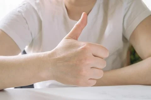 Close-up of a hand thumb up. Gesture of approval signifying that everything i Stock Photos