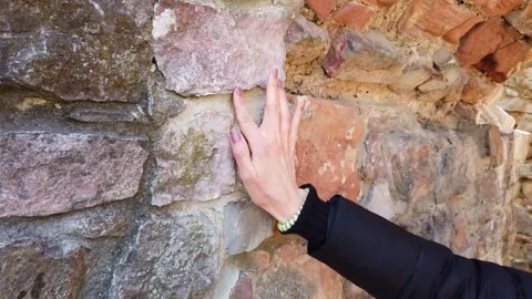 Close-up of hand touching aged stone wall outdoors in Europe Video stock 342076306