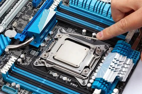 Close Up of Hand Touching CPU Socket on Modern Computer Motherboard Stock Photos