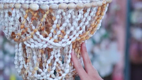 Close Up of Hand Touching Intricate Seashell Chandelier Decoration Stock Footage 329280484